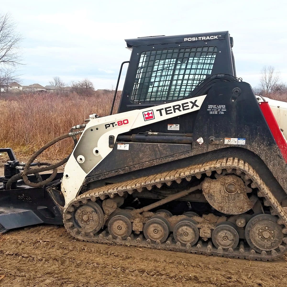 Tracked loaders and a wood chipper ready for a brush-clearing job