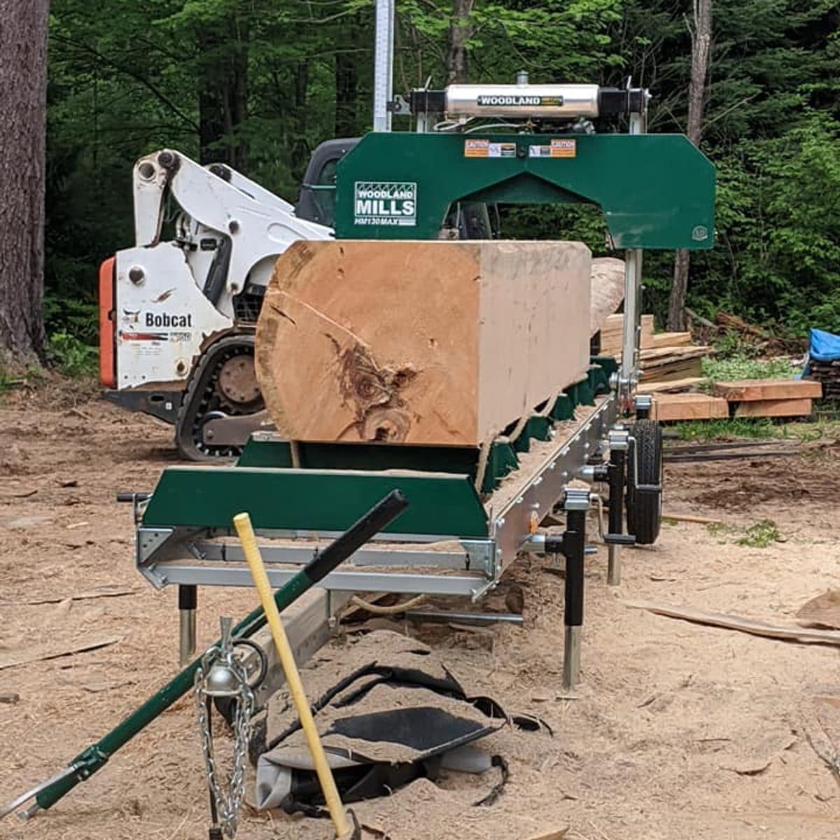 Woodland Mills sawmill set up with the Bobcat loader and a fresh log